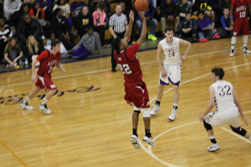 Dwayne Sutton (12, #22) shoots and makes a three. This was one of Manual's only field goals of the second half.