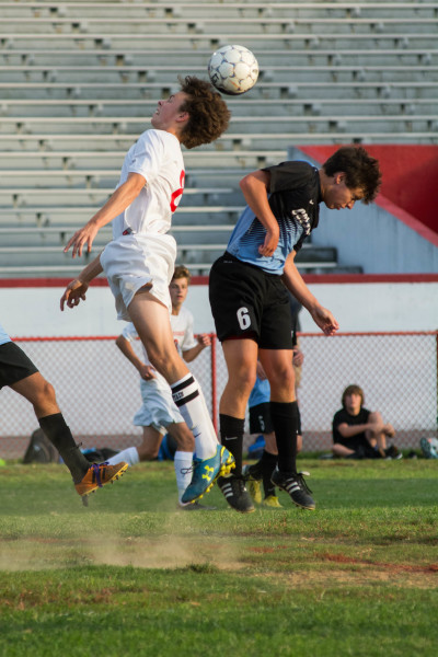 Riley Hook (12,#8) goes for a header. Photo by Luke Smith.