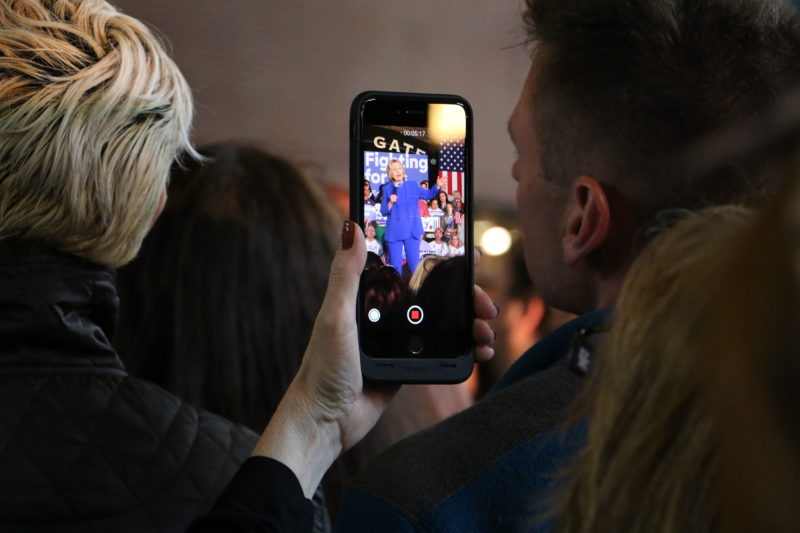A supporter at the Clinton rally takes video of Clinton. Photo by Fons Cervera. 