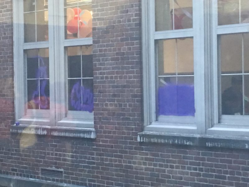 Purple spray paint mars windows in the hallway near Mr. Krause's classroom.