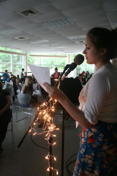 Sadie Birchfield (12) announces the next presenter for One Blue Wall's Open Mic Night. Photo by Miracle Stewart