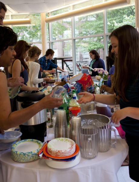 Kaitlyn Peterson (11) helps serve food to an audience member. | Photo by Meg Shanks