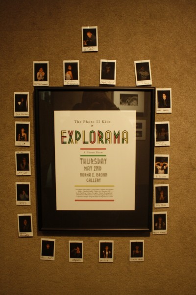 A flier was framed and hung on the wall in the front of the exhibit with pictures of all the photo 2 students hung around it.