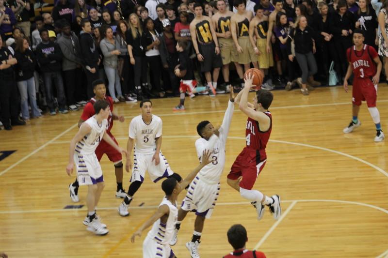 Jarrett Harness (12, #4) goes up for a shot. Harness is one of the team's leading scorers, but had a fairly quiet game.
