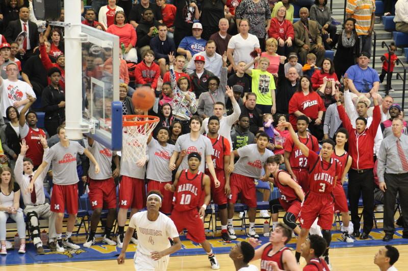 The Manual crowd anticipates a three from Chris West (#3). He misses and Jake Chilton (#34) grabs the rebound. 
