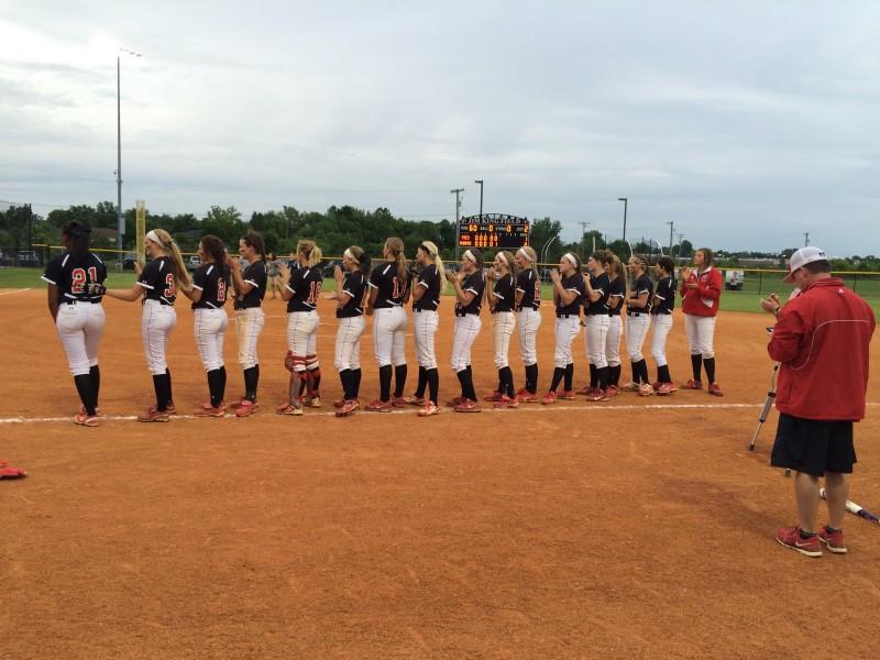 The duPont Manual softball team lines up after the game to be honored as the 25th District champions. Photo by RJ Radcliffe