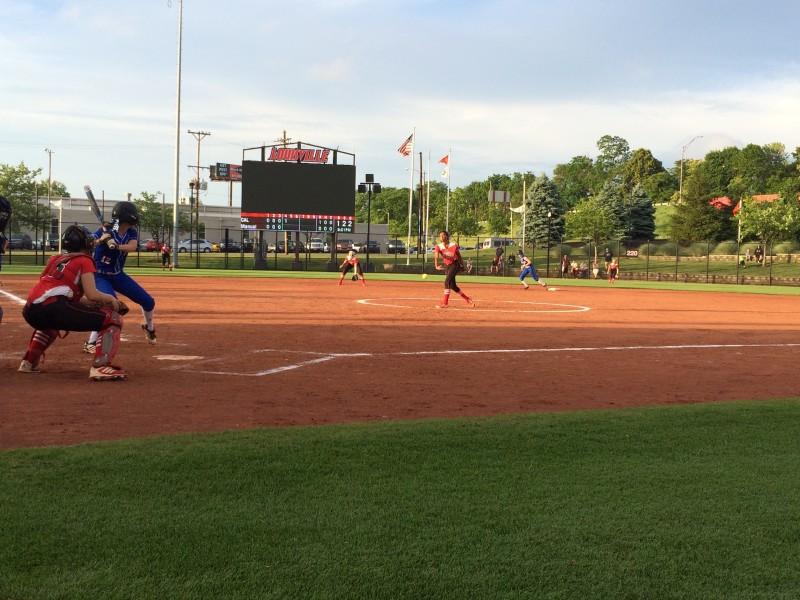 Madison Williams (11, #21) pitching to a CAL batter. Photo by RJ Radcliffe.