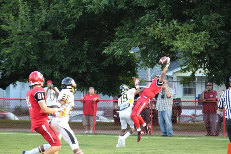 Jailen Carter (11, #11) makes a leaping catch to score Manual's first touchdown of the game. Photo by Kate Hatter 