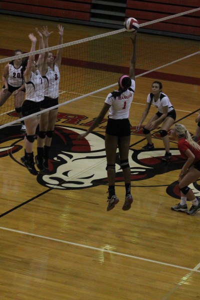 China  Brown (12, #16) tips the ball over the net to score a point on Atherton. Photo by Shea Dobson