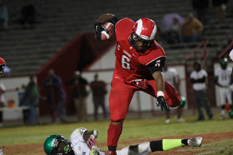 Andre Teague (11, #6) leaps over Western defender. Photo by Meaghan Sutton.