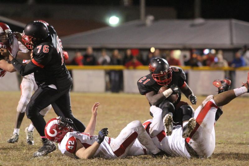 Sean Cleasant (11, #52) and Anthony Kyser (12, #42) take down PRP's Daniel Parker (12, #21). Photo by Kate Hatter