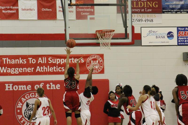 Tonysha Curry (11, ##23)showcasing her athleticism with one of her many second-chance layups.