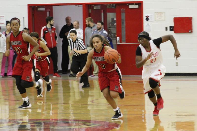 AMy Ballard (9, #3) leads the Lady Crimsons in transition on one of their many fast breaks. Photo by Kate Hatter. 