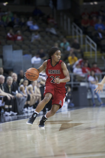 Nyah Smith (9, #25) brings the ball up court. Photo by Piper Cassetto.