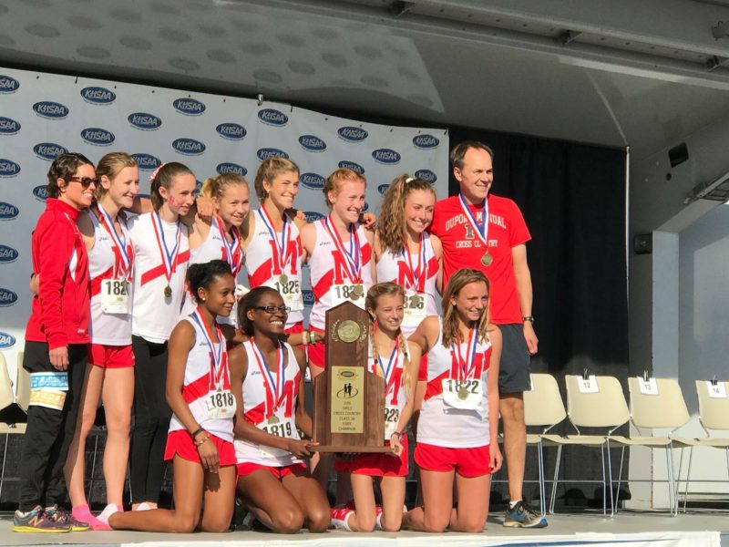 The girls' cross country team poses with the first place trophy at the state competition. Photo courtesy of Alena Sapienza-Wright.
